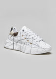 High sole sneakers with paint splatters and gold studs